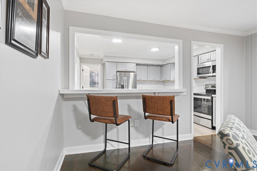 13700 Quail Meadows Lane Midlothian, VA 23112 - Photo 15 of 30 a kitchen with stainless steel appliances kitchen island hardwood floor and sink