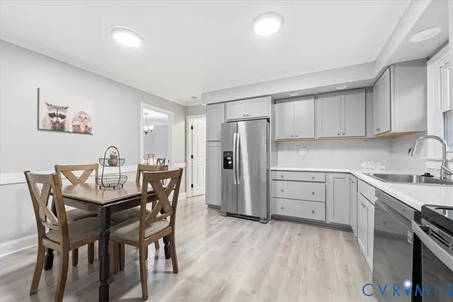 a kitchen with stainless steel appliances granite countertop a sink and a stove