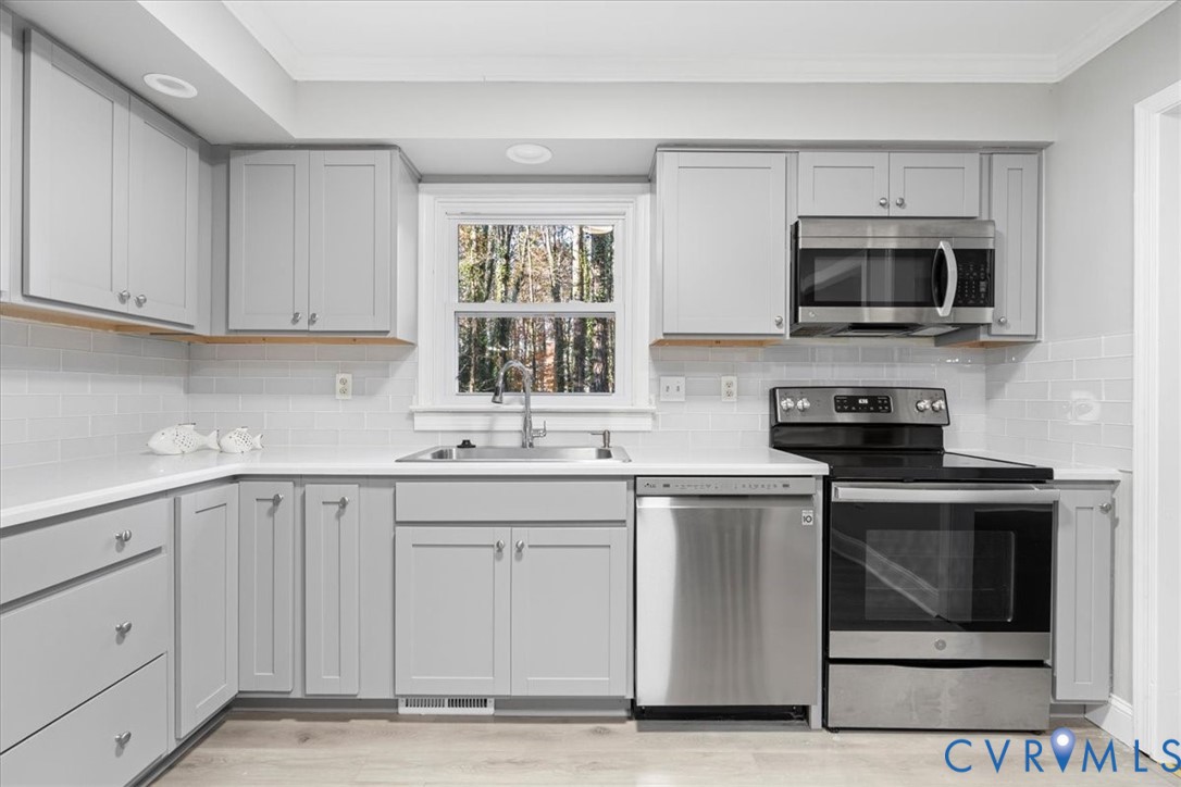 13700 Quail Meadows Lane Midlothian, VA 23112 - Photo 17 of 30 a kitchen with stainless steel appliances granite countertop a sink and a stove