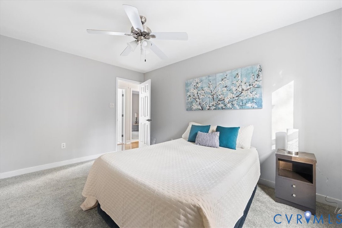 13700 Quail Meadows Lane Midlothian, VA 23112 - Photo 21 of 30 a bedroom with a large bed and a chandelier