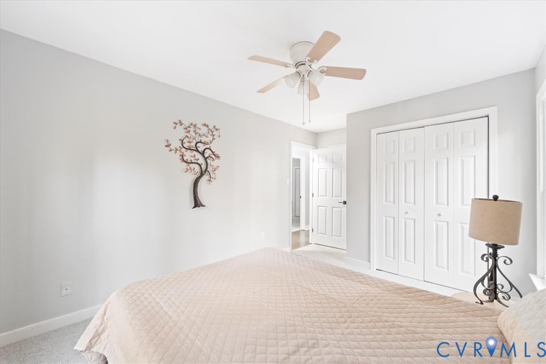 13700 Quail Meadows Lane Midlothian, VA 23112 - Photo 24 of 30 a bedroom with a bed and a chandelier