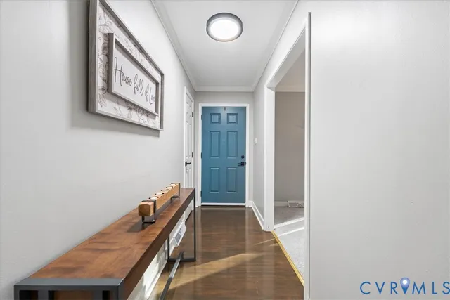 a view of a hallway with wooden floor and staircase