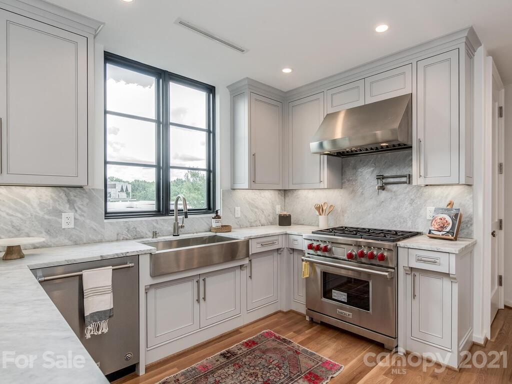 1333 Queens Road, Unit B4 Charlotte, NC 28207 - Photo 12 of 27 a kitchen with a sink stove and cabinets