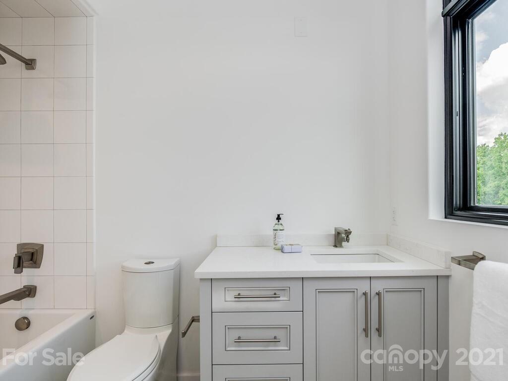 1333 Queens Road, Unit B4 Charlotte, NC 28207 - Photo 15 of 27 a bathroom with a sink toilet and window