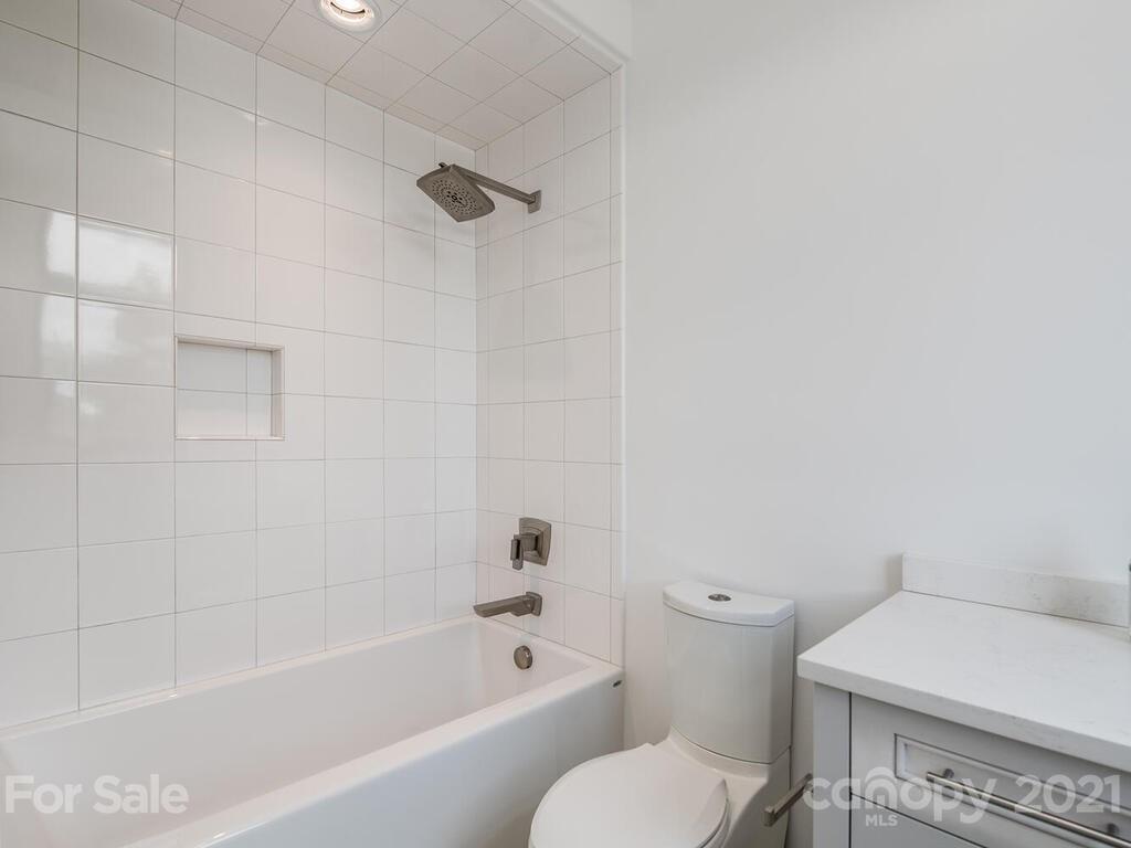 1333 Queens Road, Unit B4 Charlotte, NC 28207 - Photo 16 of 27 a white bath tub sitting next to a white toilet and sink