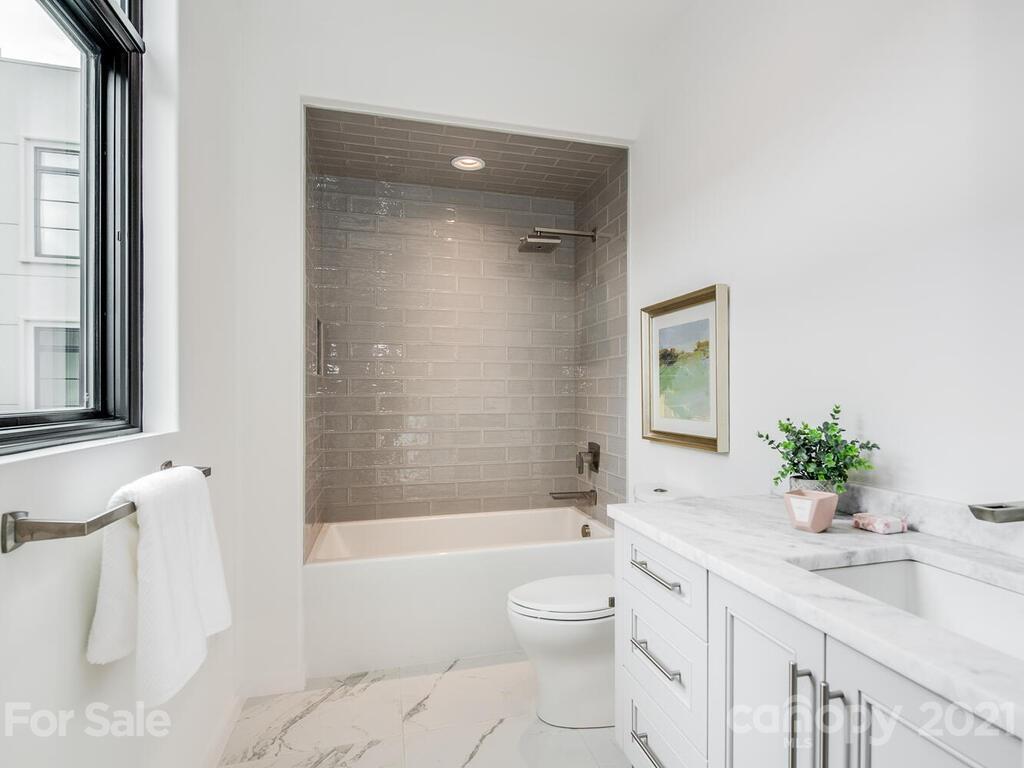 1333 Queens Road, Unit B4 Charlotte, NC 28207 - Photo 18 of 27 a bathroom with a granite countertop sink toilet and shower