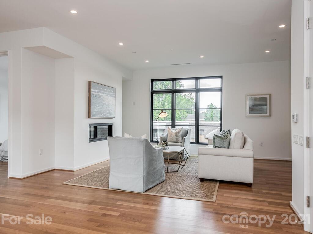 1333 Queens Road, Unit B4 Charlotte, NC 28207 - Photo 5 of 27 a living room with furniture and a large window