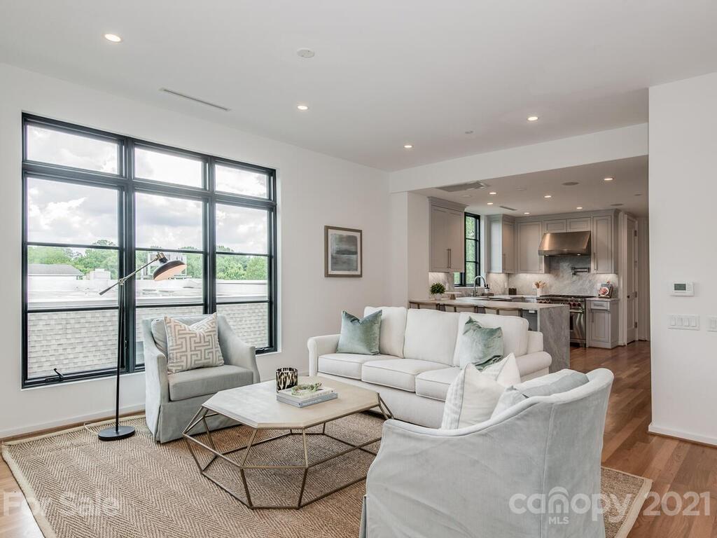 1333 Queens Road, Unit B4 Charlotte, NC 28207 - Photo 7 of 27 a living room with furniture and a large window