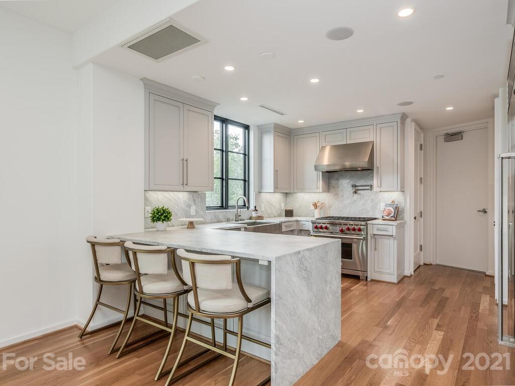 1333 Queens Road, Unit B4 Charlotte, NC 28207 - Photo 10 of 27 a kitchen with a table chairs stove and cabinets