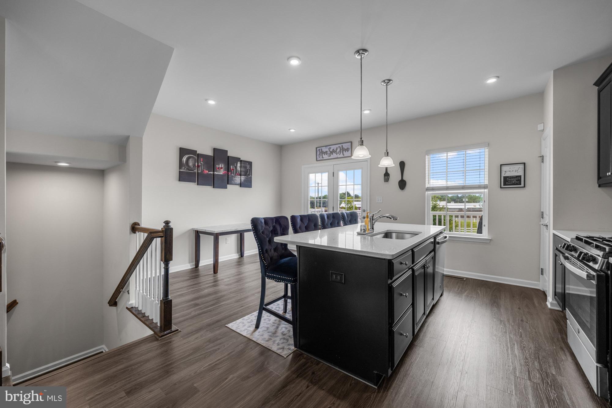 607 Sammy Street Swedesboro, NJ 08085 - Photo 14 of 37 a kitchen with a stove a refrigerator a sink dishwasher with a dining table and chairs