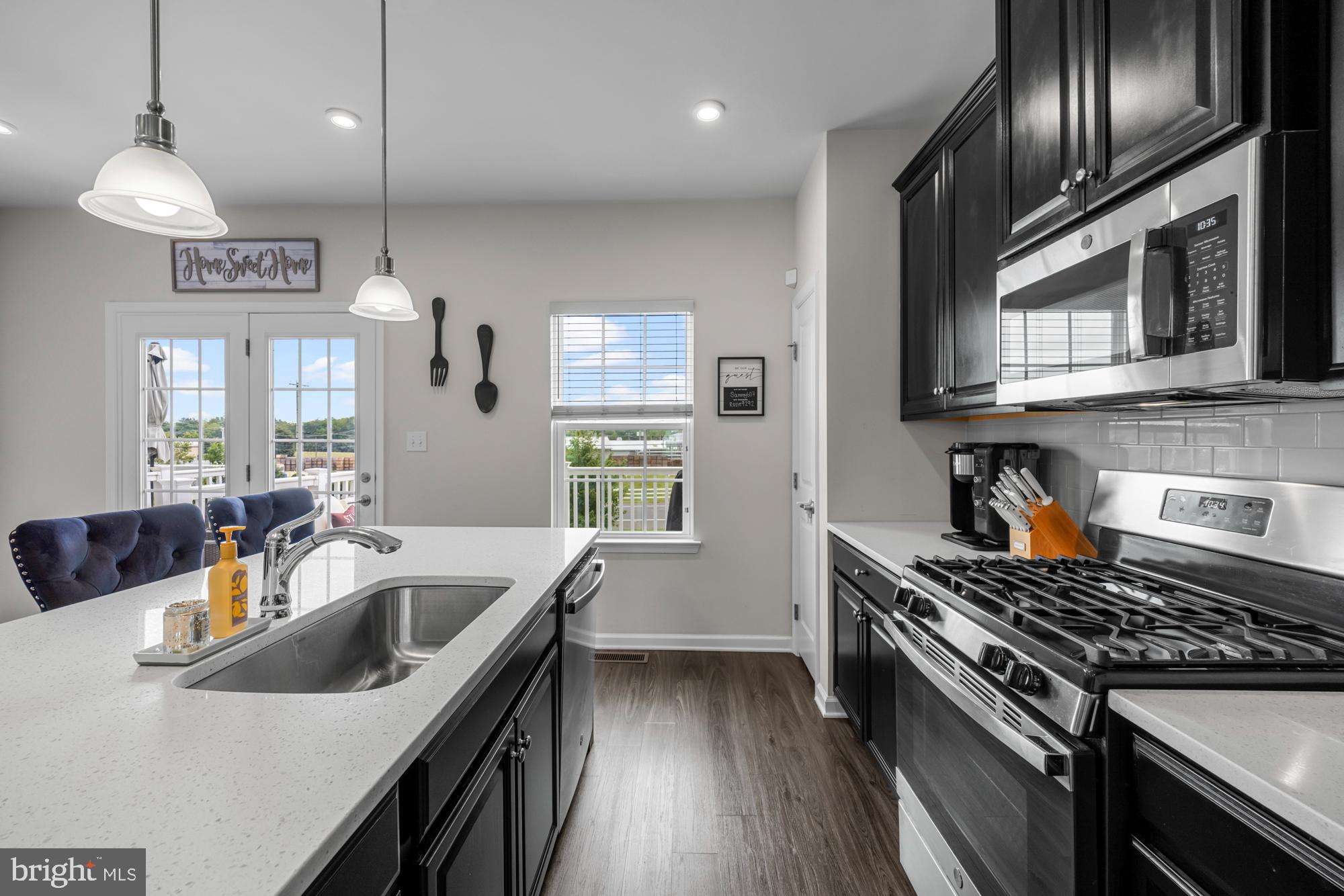 607 Sammy Street Swedesboro, NJ 08085 - Photo 15 of 37 a kitchen with stainless steel appliances granite countertop a sink a stove and a wooden floors