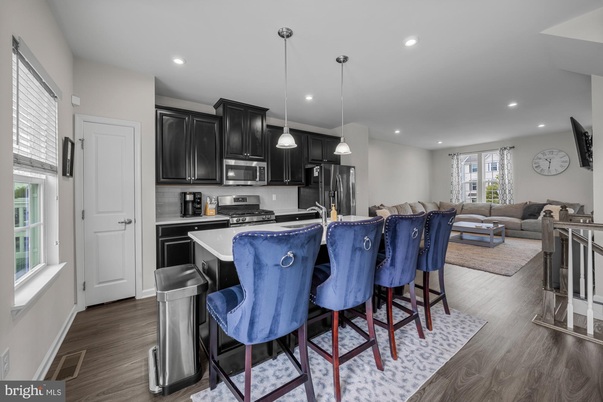 607 Sammy Street Swedesboro, NJ 08085 - Photo 17 of 37 a kitchen with a dining table chairs and wooden floor