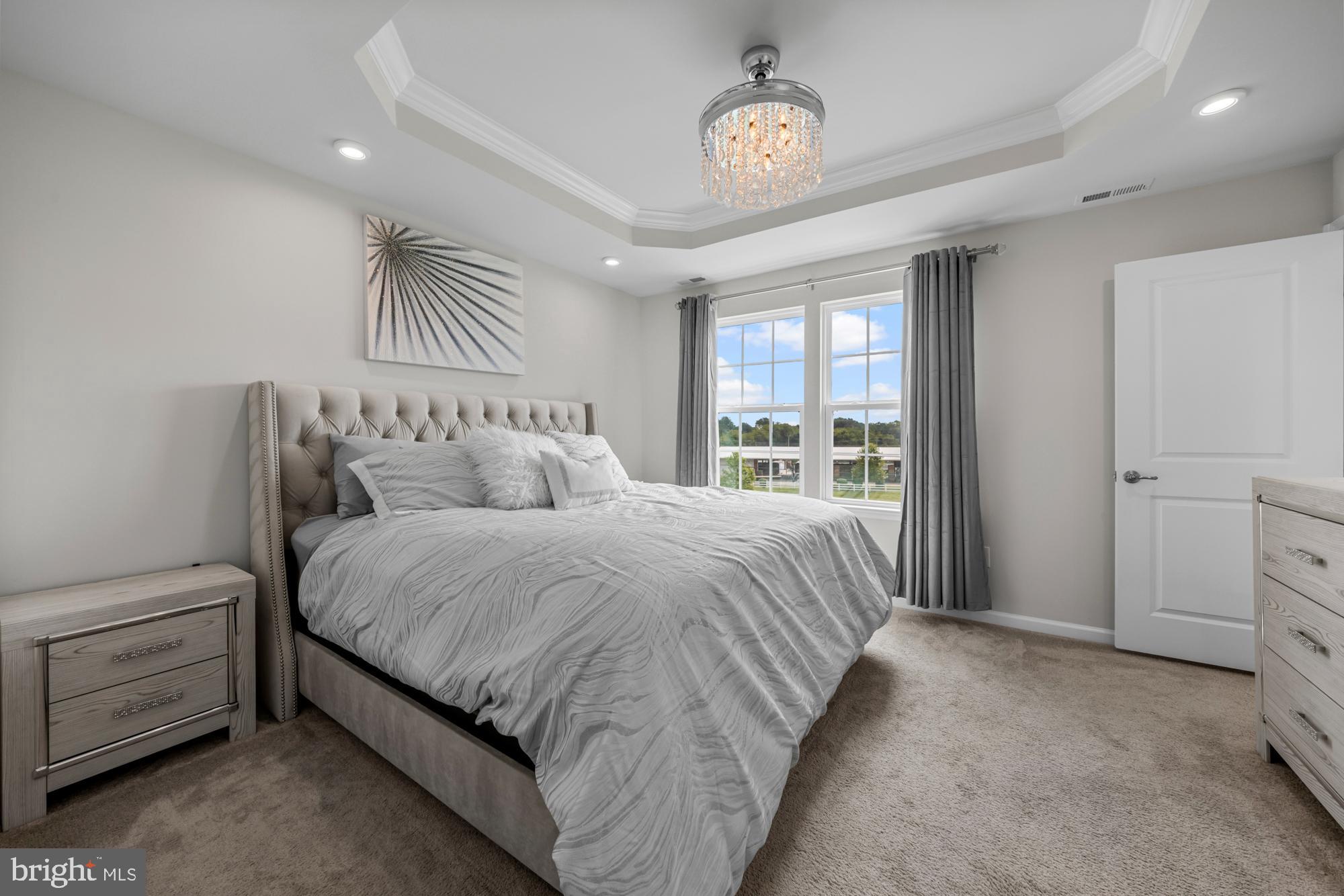 607 Sammy Street Swedesboro, NJ 08085 - Photo 23 of 37 a bedroom with a large bed and a chandelier