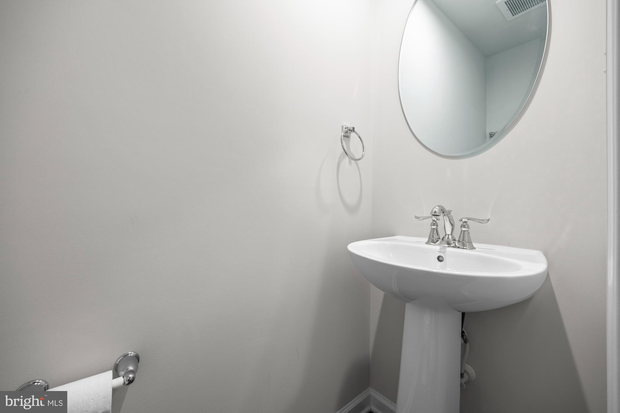 607 Sammy Street Swedesboro, NJ 08085 - Photo 7 of 37 a bathroom with a sink a mirror and a toilet