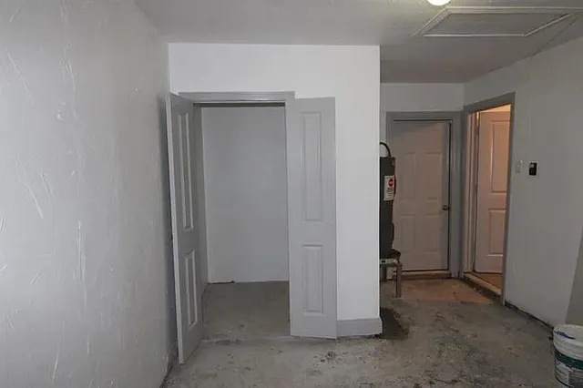 a view of backyard of house with green space