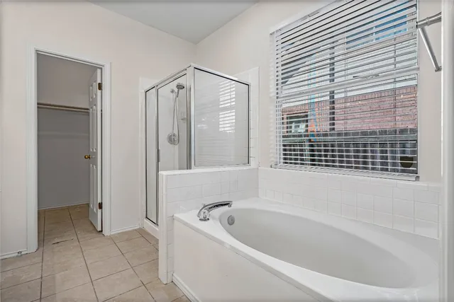 a bathroom with a bathtub and a shower