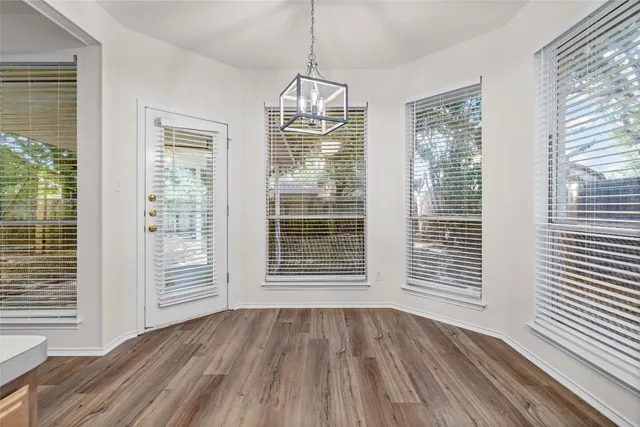 a view of wooden floor and windows in a room