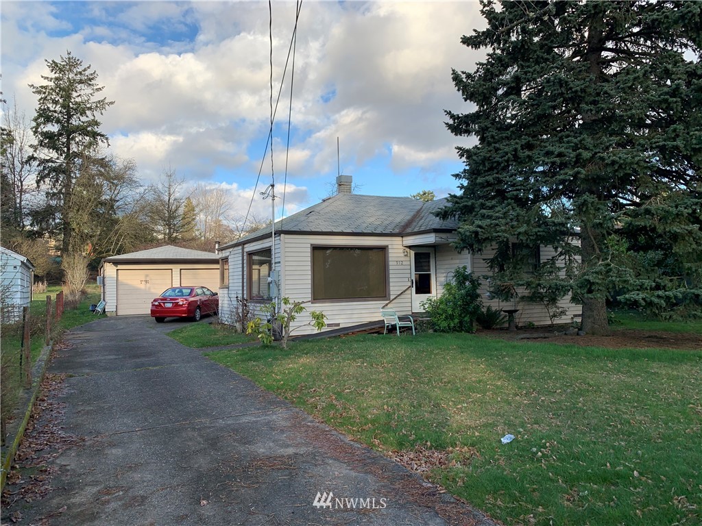 912 Southwest 3rd Place Renton, WA 98057 - Photo 1 of 20 a view of a house with a backyard and a garden