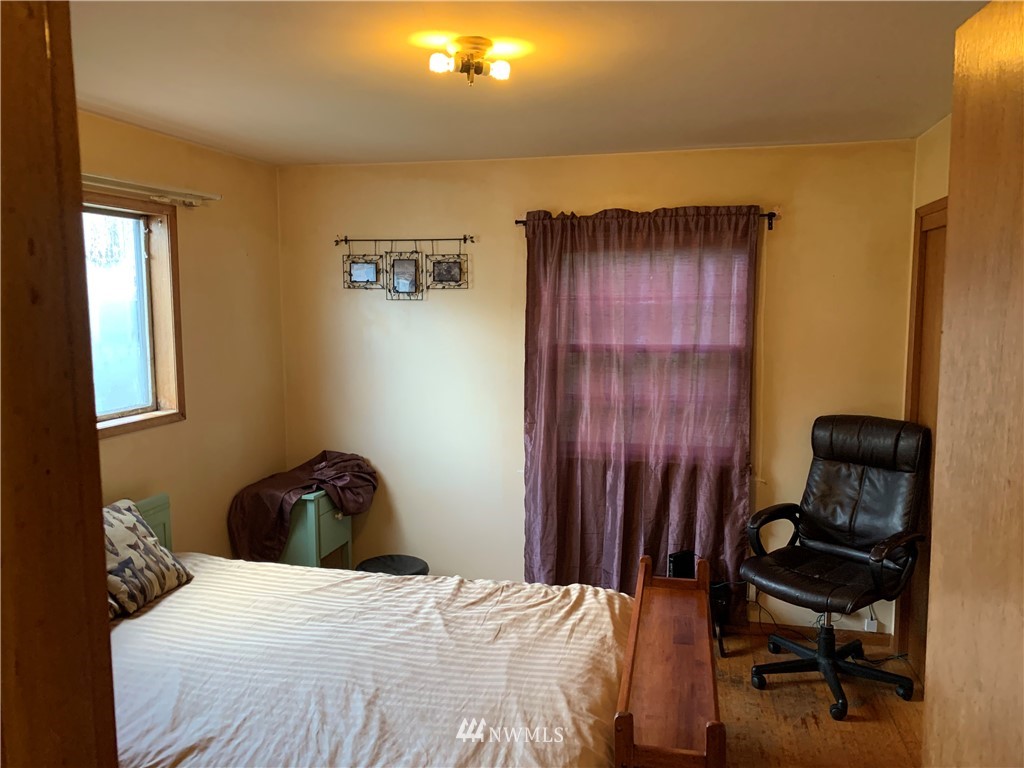 912 Southwest 3rd Place Renton, WA 98057 - Photo 12 of 20 a bedroom with a bed and a chair