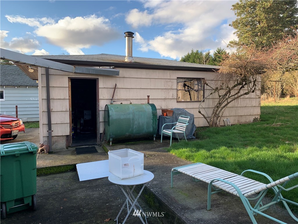 912 Southwest 3rd Place Renton, WA 98057 - Photo 19 of 20 a view of a chair and table in back yard of the house