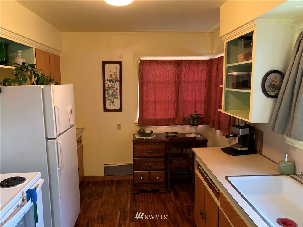 912 Southwest 3rd Place Renton, WA 98057 - Photo 8 of 20 a kitchen with a refrigerator and a stove top oven