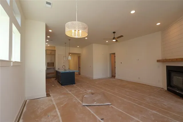 a view of an empty room with a kitchen