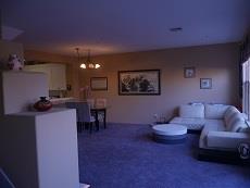 130 Sutter Creek Lane San Ramon, CA 94583 - Photo 6 of 10 a living room with furniture and a dining table with kitchen countertops