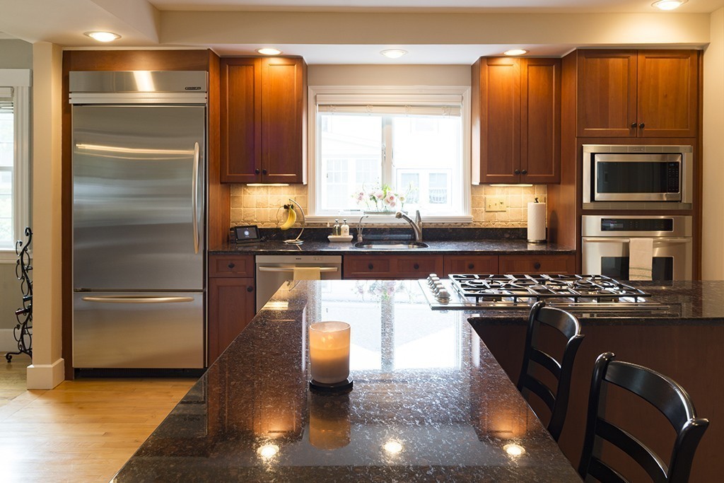 5 Hidden Road Andover, MA 01810 - Photo 12 of 30 a kitchen with granite countertop stainless steel appliances and wooden cabinets
