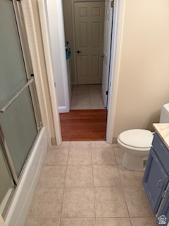 254 Meadow Lane Centerville, UT 84014 - Photo 23 of 34 Bathroom featuring a tub with sliding glass doors, tile flooring, and a vanity with a light-colored countertop