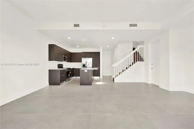 a view of kitchen with furniture and cabinets