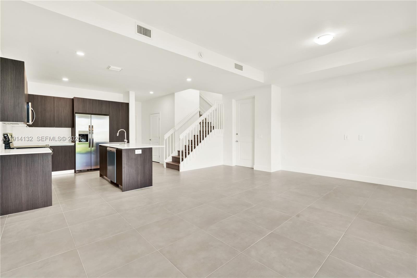 34520 Southwest 191st Court, Unit 34520 Homestead, FL 33034 - Photo 16 of 37 a large room with stainless steel appliances lots of white cabinets