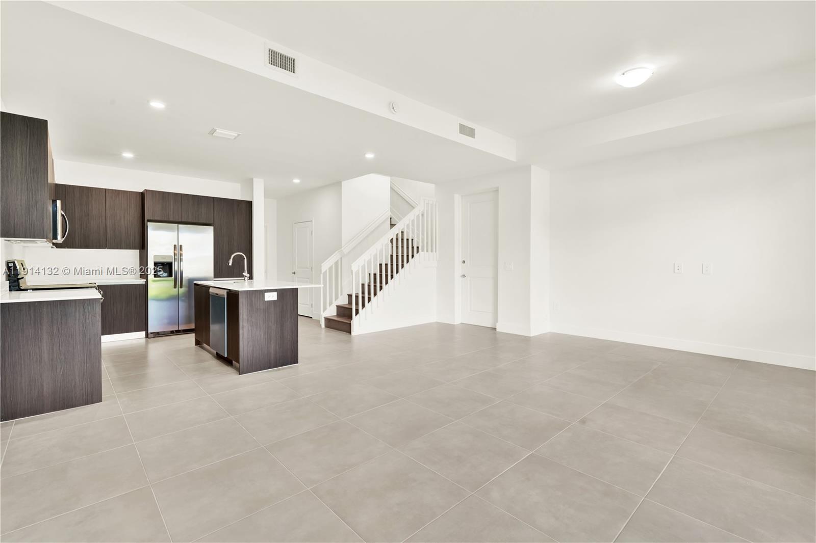 34520 Southwest 191st Court, Unit 34520 Homestead, FL 33034 - Photo 16 of 37 a large room with stainless steel appliances lots of white cabinets