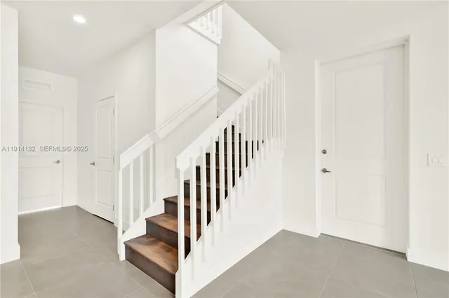 a view of staircase with white walls