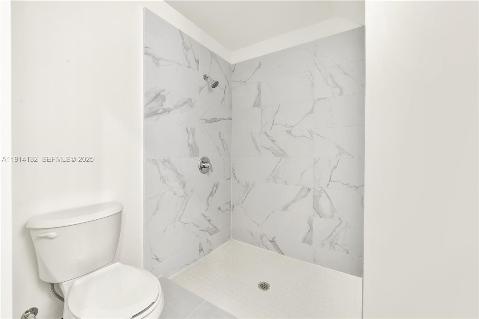 34520 Southwest 191st Court, Unit 34520 Homestead, FL 33034 - Photo 19 of 37 a bathroom with a toilet and shower