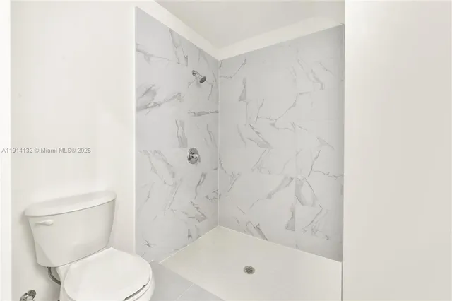 a bathroom with a toilet and shower