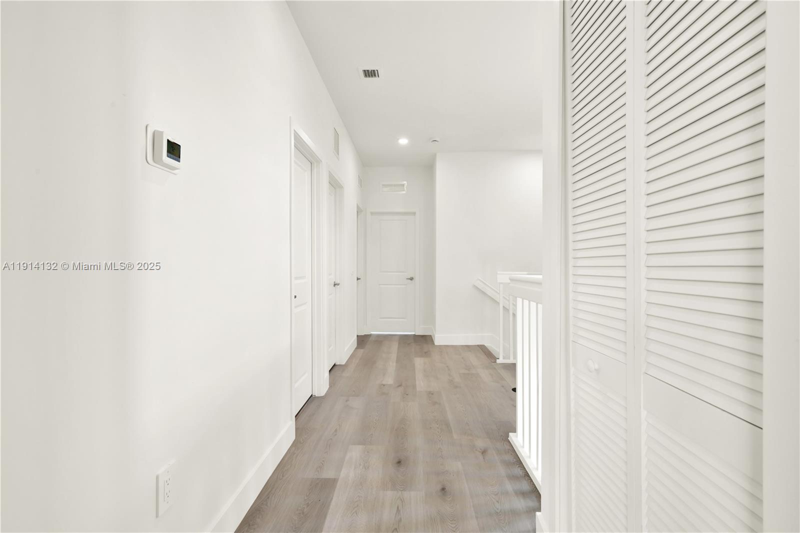 34520 Southwest 191st Court, Unit 34520 Homestead, FL 33034 - Photo 23 of 37 a view of a hallway with wooden floor