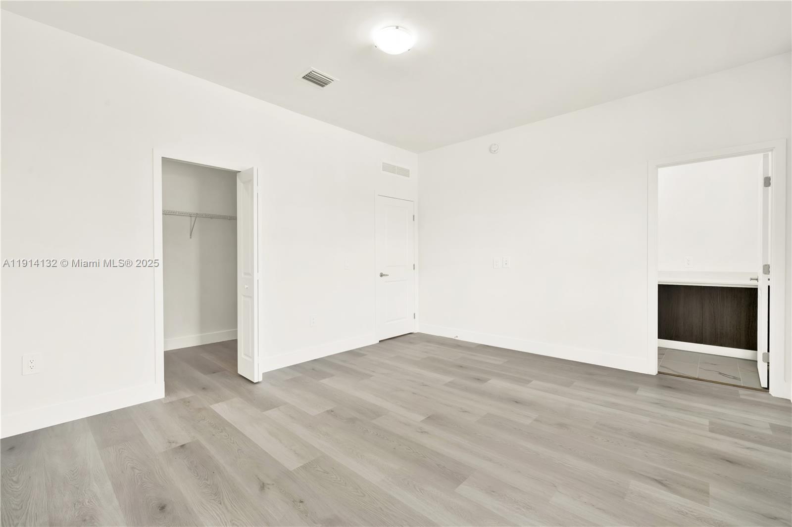 34520 Southwest 191st Court, Unit 34520 Homestead, FL 33034 - Photo 32 of 37 an empty room with wooden floor and windows