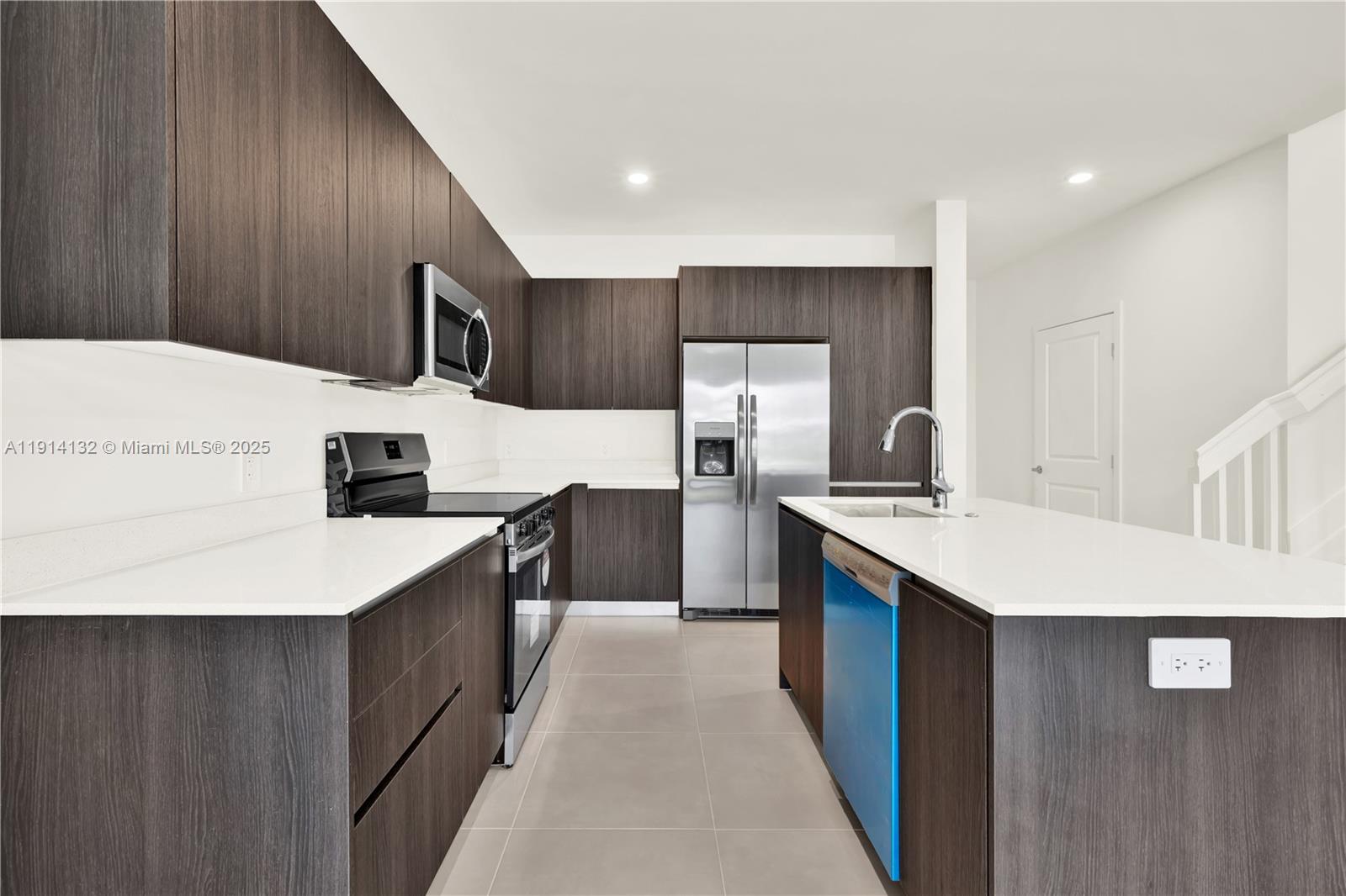 34520 Southwest 191st Court, Unit 34520 Homestead, FL 33034 - Photo 7 of 37 a kitchen with stainless steel appliances a sink and a refrigerator