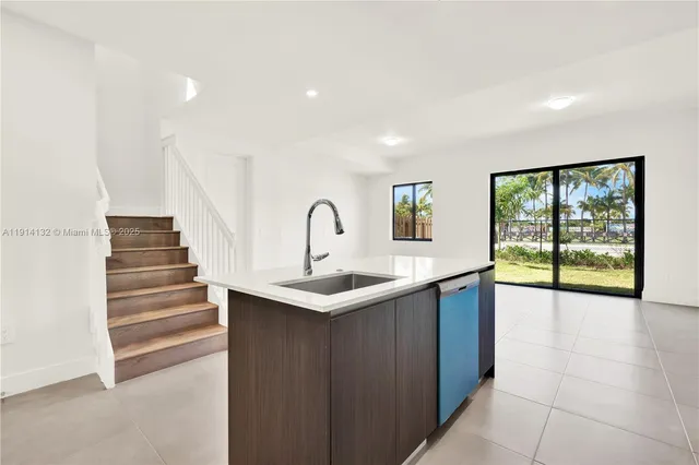 a kitchen with sink and window