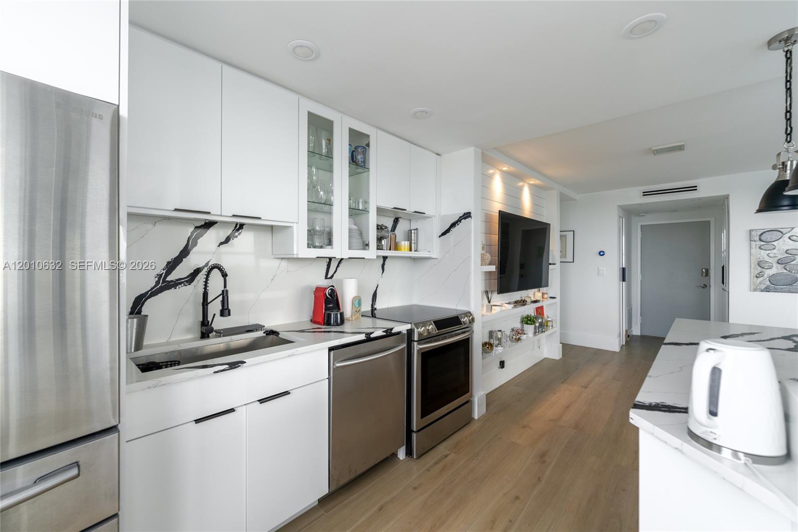 2639 North Riverside Drive, Unit 501 Pompano Beach, FL 33062 - Photo 5 of 39 a kitchen that has a sink and a stove in it