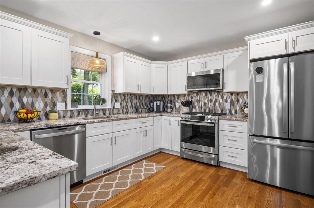16 Farnum Street, Unit 16 Uxbridge, MA 01569 - Photo 13 of 34 a kitchen with a sink stove and refrigerator