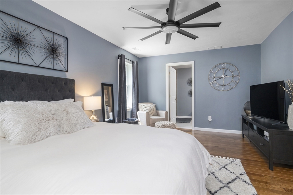 16 Farnum Street, Unit 16 Uxbridge, MA 01569 - Photo 18 of 34 a bedroom with a large bed and a flat tv screen on a dresser