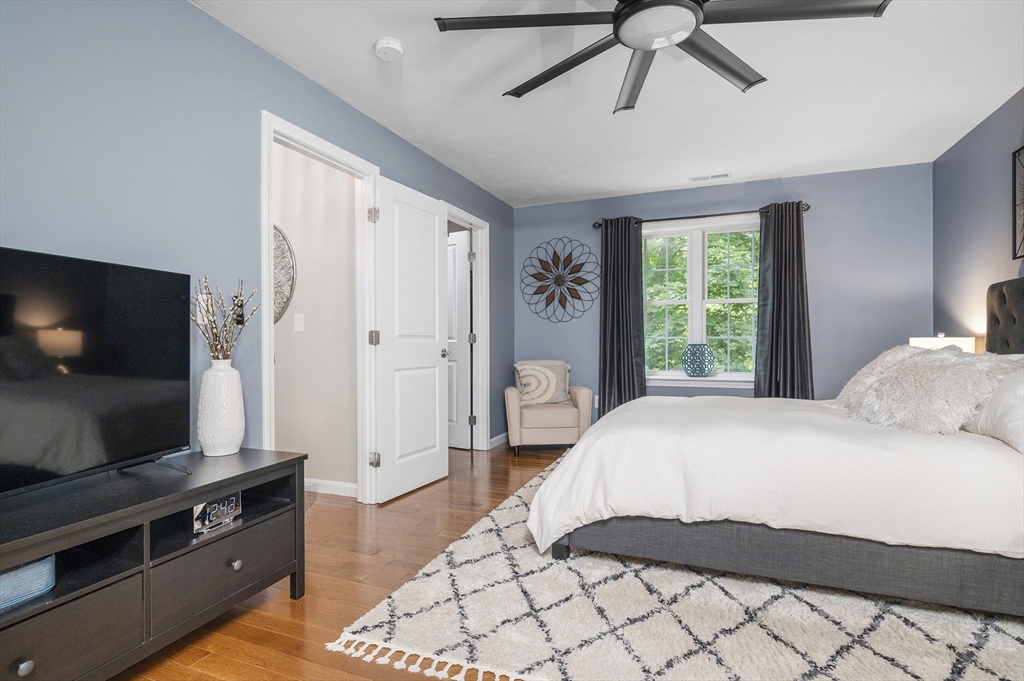 16 Farnum Street, Unit 16 Uxbridge, MA 01569 - Photo 19 of 34 a bedroom with a bed and a flat screen tv