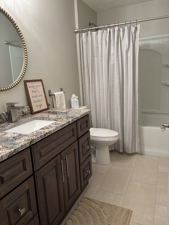 16 Farnum Street, Unit 16 Uxbridge, MA 01569 - Photo 25 of 34 a bathroom with a granite countertop sink and a mirror