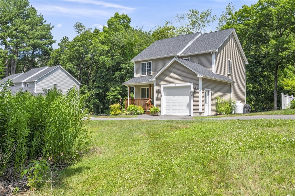 16 Farnum Street, Unit 16 Uxbridge, MA 01569 - Photo 28 of 34 a front view of a house with yard and green space