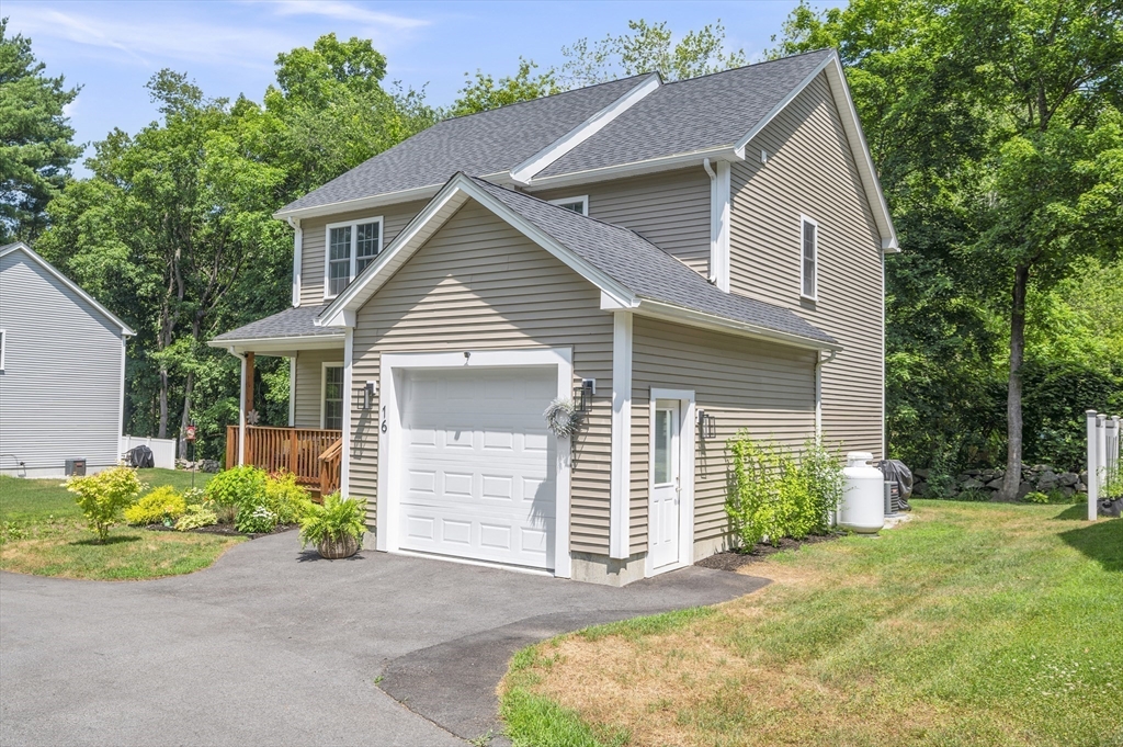 16 Farnum Street, Unit 16 Uxbridge, MA 01569 - Photo 29 of 34 a front view of a house with a yard and garage