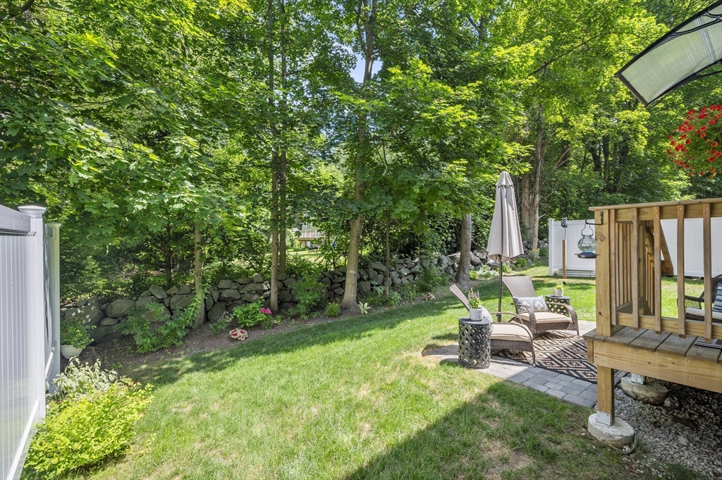 16 Farnum Street, Unit 16 Uxbridge, MA 01569 - Photo 31 of 34 a backyard of a house with table and chairs