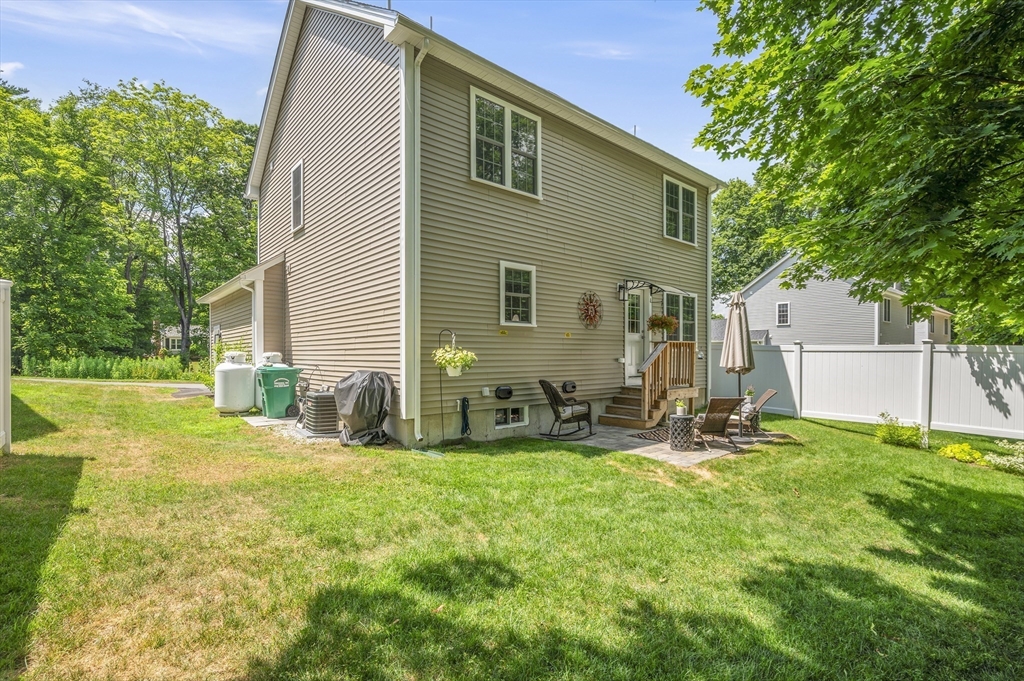 16 Farnum Street, Unit 16 Uxbridge, MA 01569 - Photo 33 of 34 a view of a backyard with a sitting area and a small yard