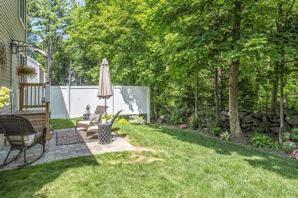 16 Farnum Street, Unit 16 Uxbridge, MA 01569 - Photo 34 of 34 a view of backyard with table and chairs and wooden fence
