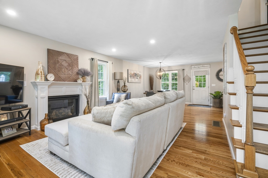 16 Farnum Street, Unit 16 Uxbridge, MA 01569 - Photo 4 of 34 a living room with furniture a flat screen tv and a fireplace